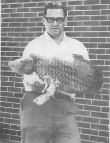Rev. Donald Clark holds a large common carp.