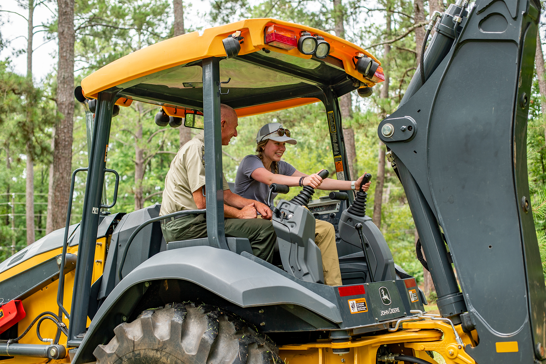 a student operating a backhoe 